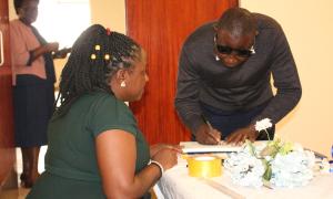 Alice Mwijukye, a Librarian helping a Farmer with registration during the Busitema Open Access week event at the Faculty Of Engineering library on 20th October 2025