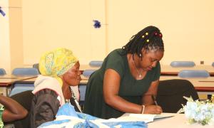 Alice Mwijukye, a librarian at the Faculty Of Engineering library helping a participant register during the Busitema Open Access week celebrations. This was at the Faculty Of Engineering library on 20th October 2025.