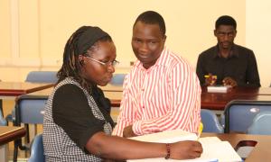 Kisombo Gerald (R), a Library Staff, assisting a student with registration during the International Open Access Week celebrations at the Faculty of Engineering Library, Busitema University, on 20th October 2025.”